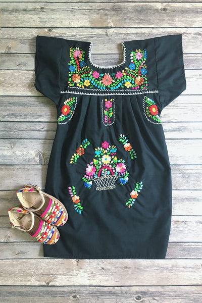 ShopMucho little girls Mexican dress embroidered with colorful flowers in black flatlay